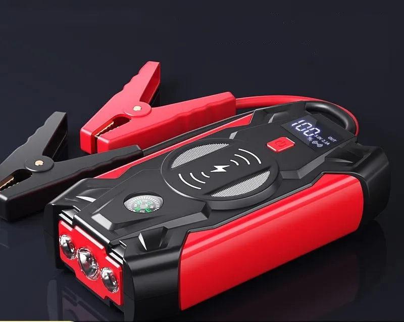 Red portable car jump starter unit with booster clamps and charger in storage box