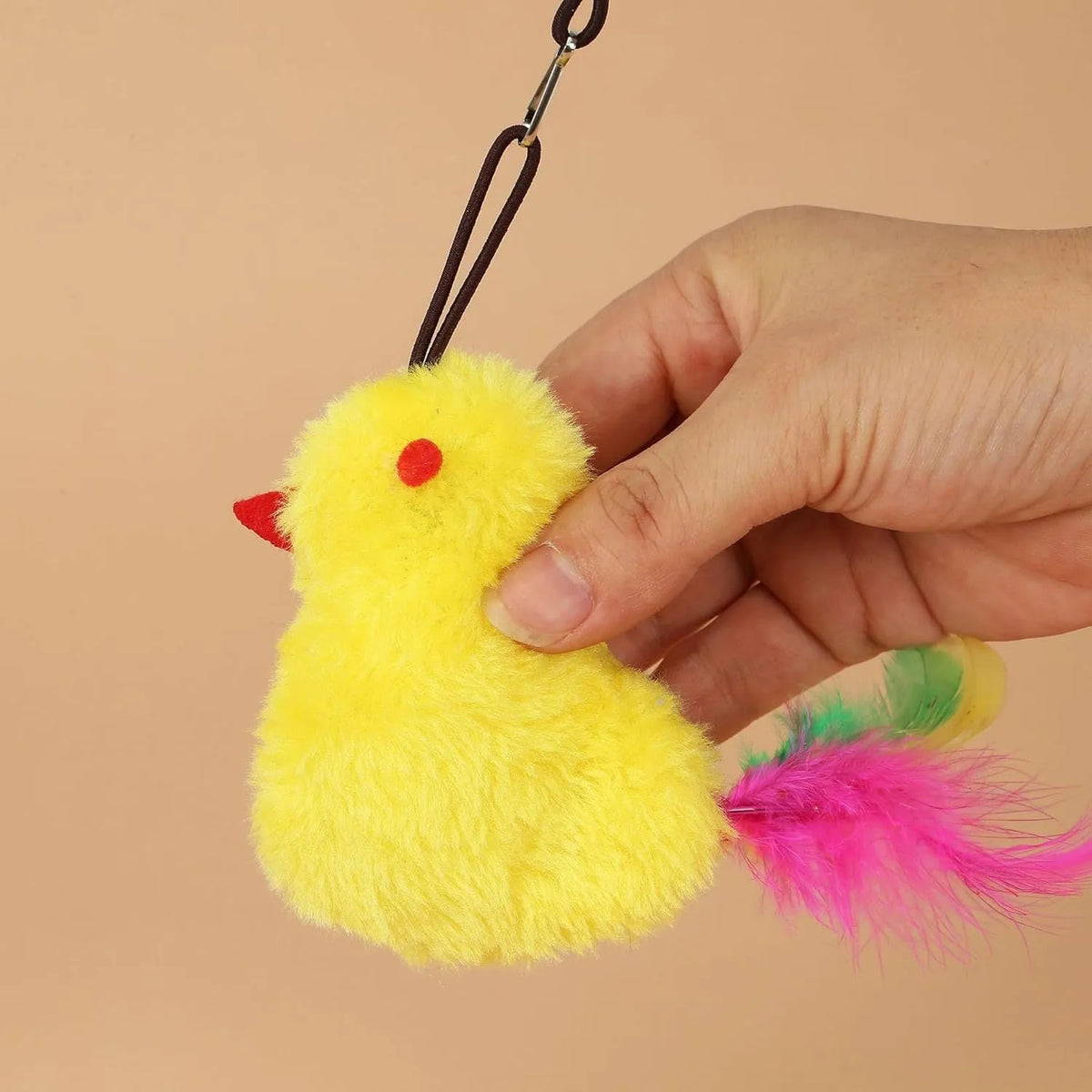 Grey and yellow interactive cat toy hanging on door with dangling mouse, treat bulb, and retractable cord