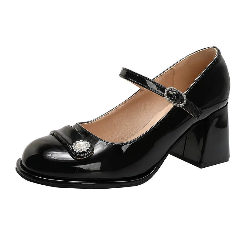 Women's black patent leather chunky heel shoes with round toe and buckle strap.
