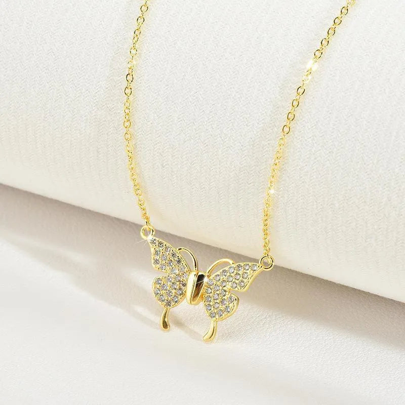 Gold titanium steel women's butterfly charm necklace on a twisted chain with magnetic clasp.