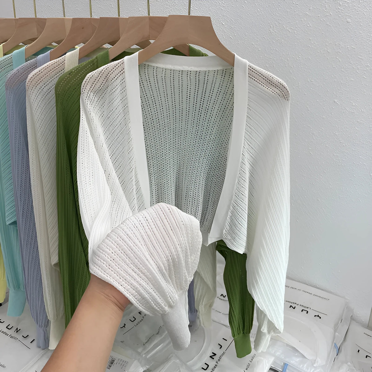 Women's hollow out blouse with long lantern sleeves in a linen blend fabric, shown in apricot colour.