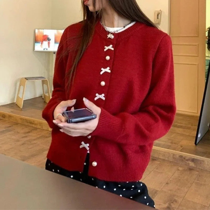 Women's light blue cashmere blend cardigan sweater with pearl buttons and bow detailing on front