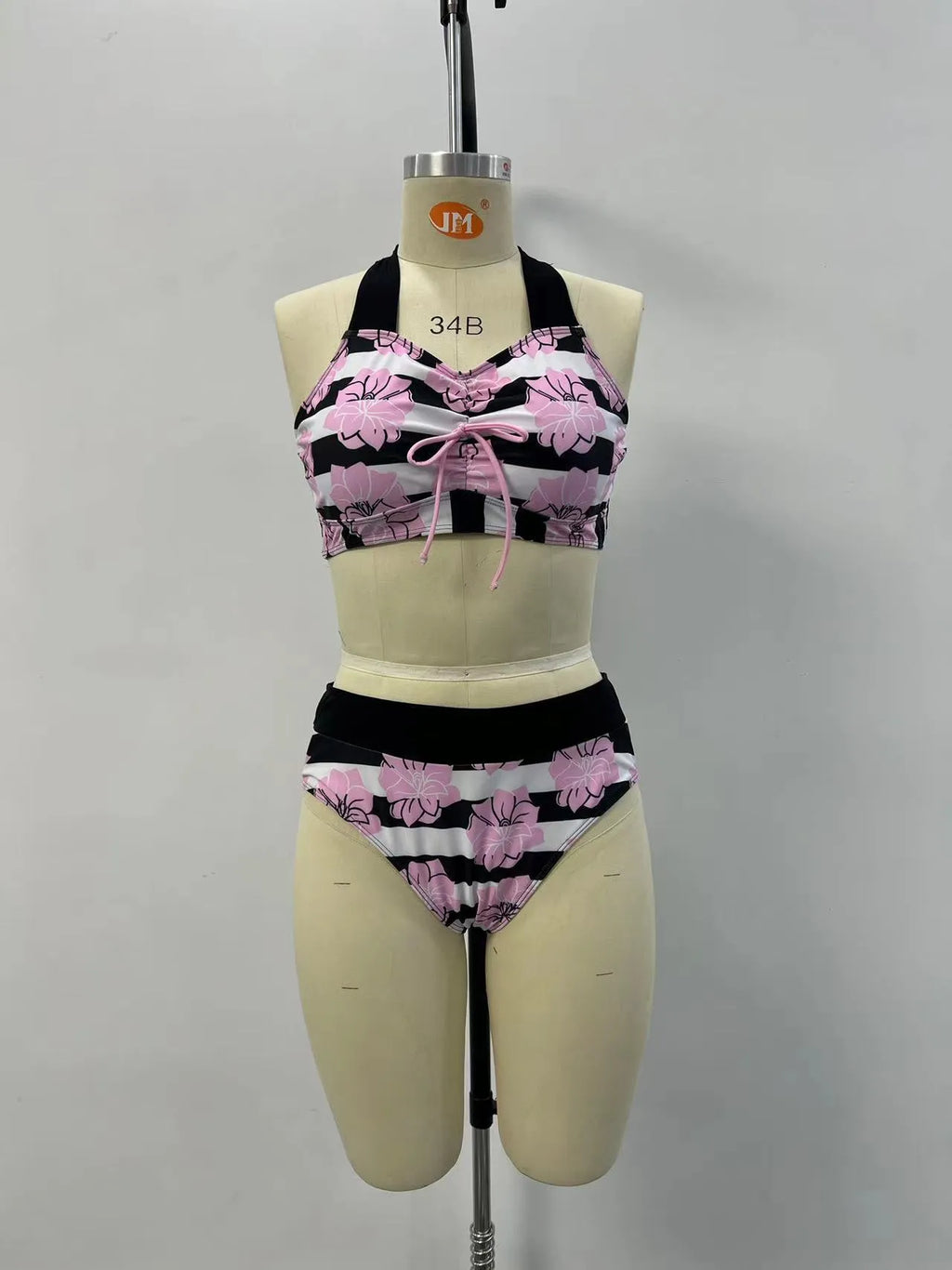 Black women's printed bikini with belly cover and split-leg design for swimming.