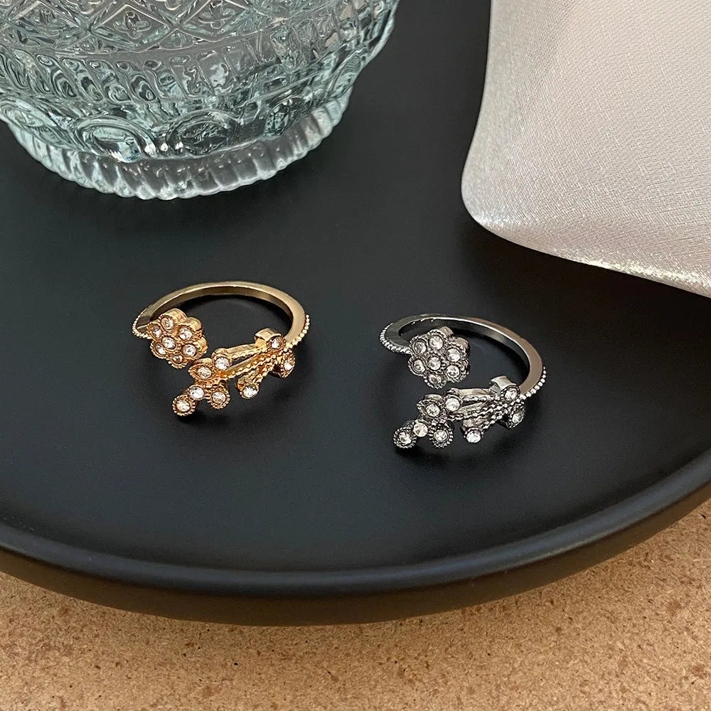 Copper open ring with flower and leaf design in gold colour.