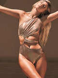 Gold backless one-piece swimsuit for women on a white background.