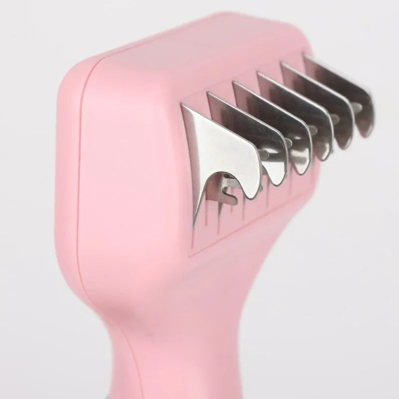 Pink pet grooming comb with stainless steel knot cutter blade and massage pins on a plastic handle.