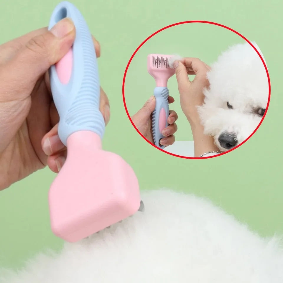 Pink pet grooming comb with stainless steel knot cutter blade and massage pins on a plastic handle.
