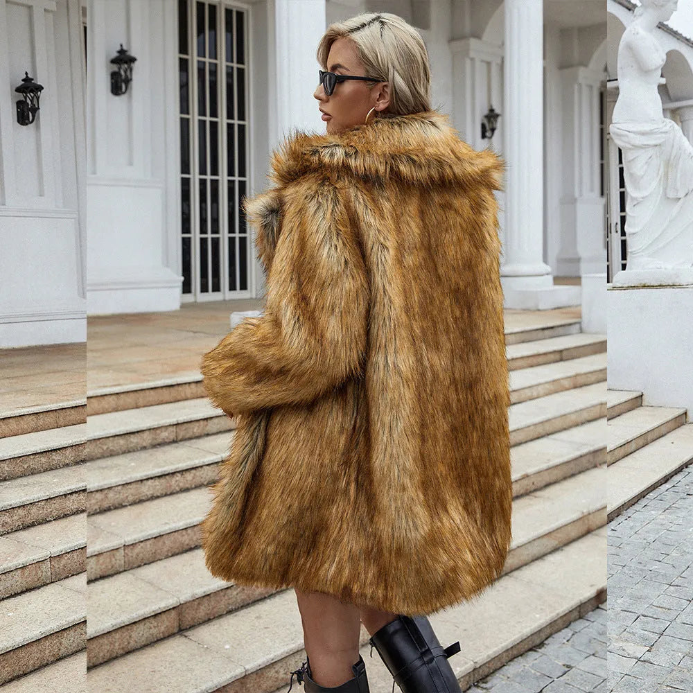 Yellow women's loose mid-length faux fur coat on a hanger.