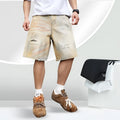 Light blue distressed denim shorts for men with ripped details and straight-leg fit.