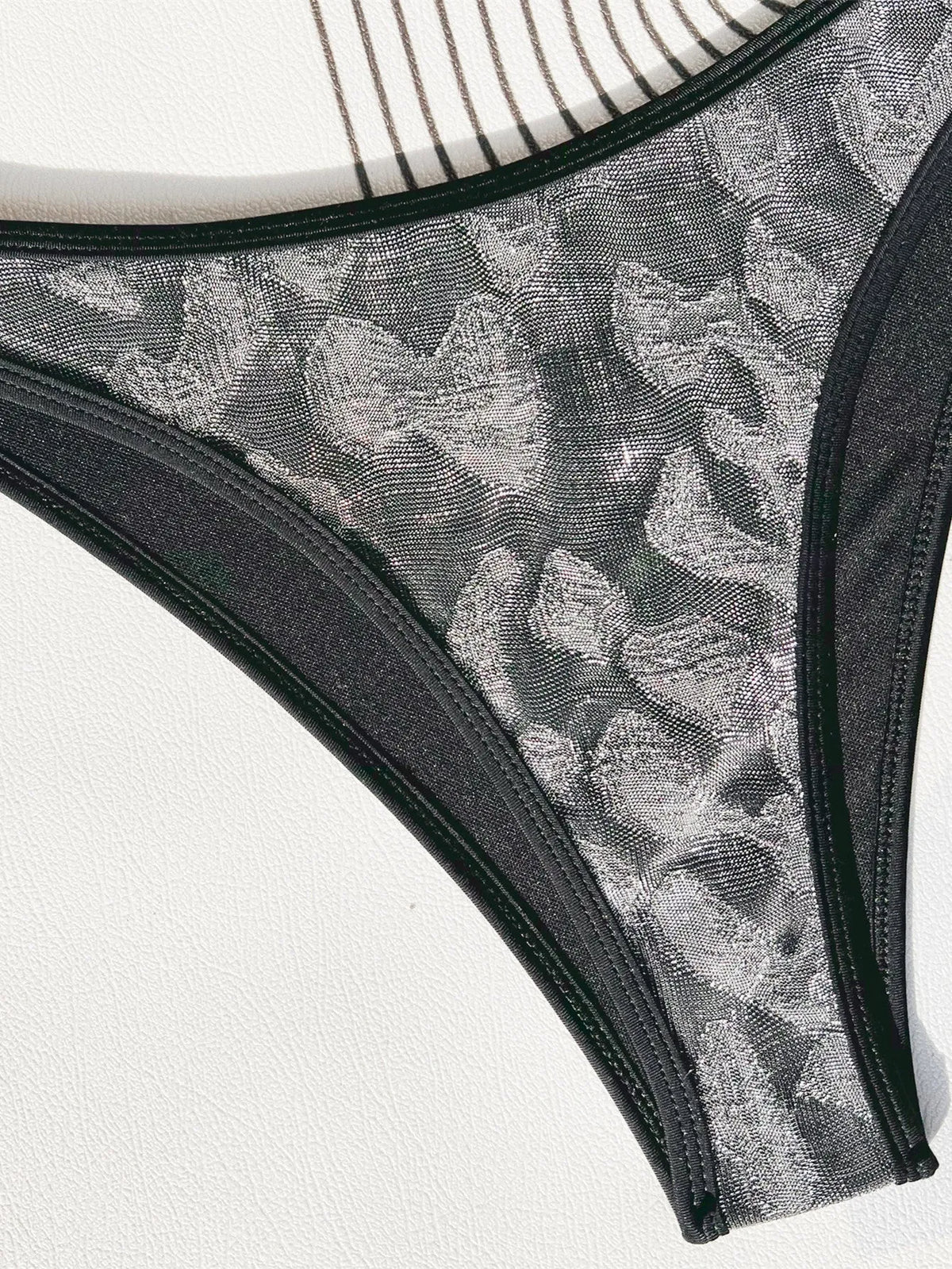 Ladies black polyester bikini set with adjustable straps, shown on a mannequin.