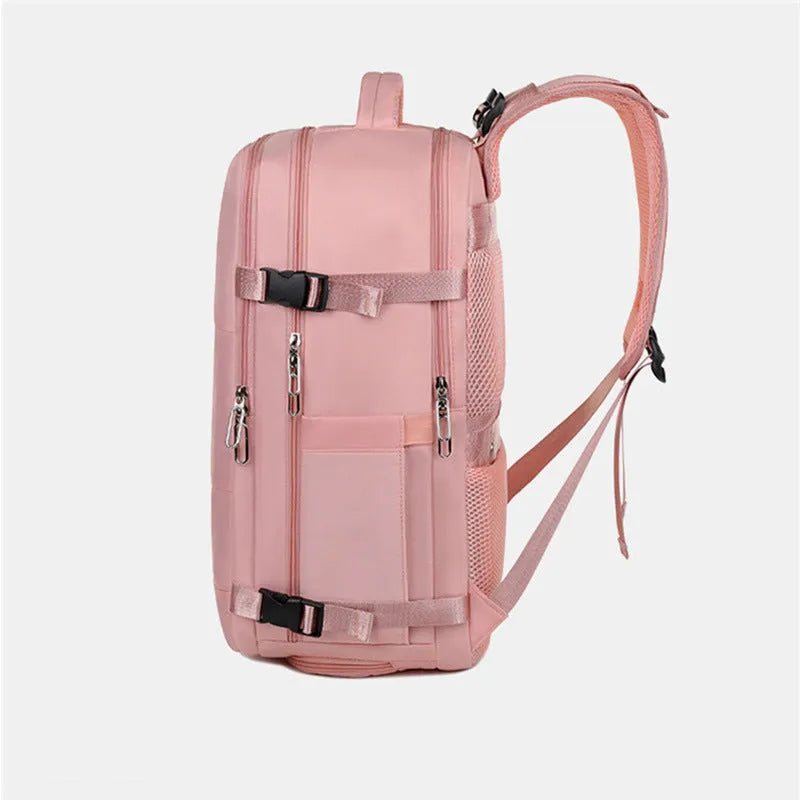 Large purple travel backpack with multiple compartments, shown next to a laptop.