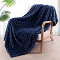 Soft polyester velvet children's plaid blanket in camel colour, shown in a 90x90 inch size on a bed.