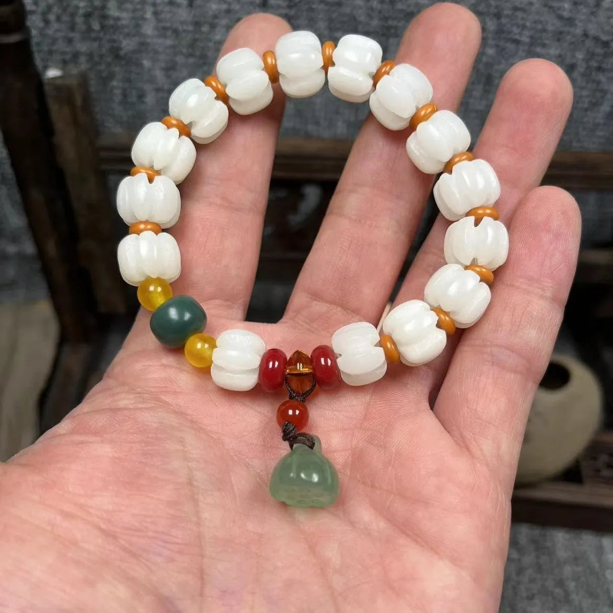 Carved bodhi root bracelet with pumpkin lotus beads and white jade lotus detailing in multiple bead sizes