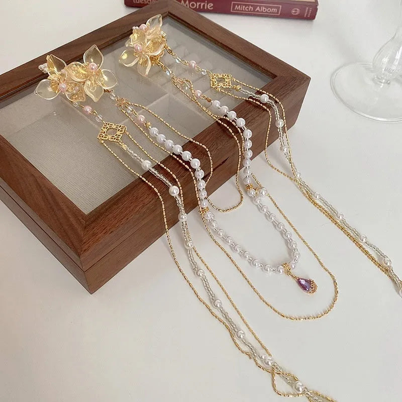 Gold women's hairpin with diamond grip and long tassel design
