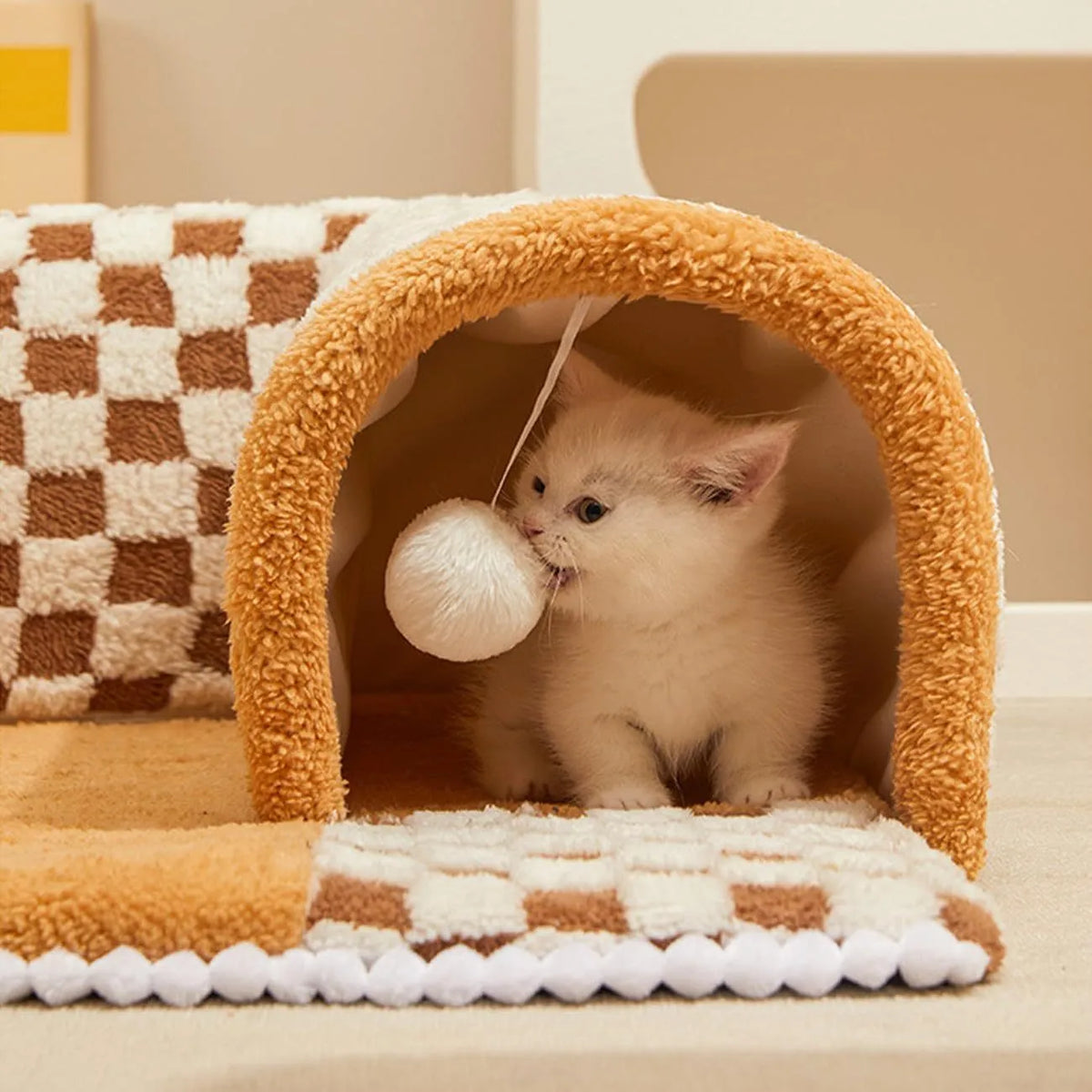 Coffee coloured fan-shaped plush pet bed with a tunnel entrance and anti-slip granular base.