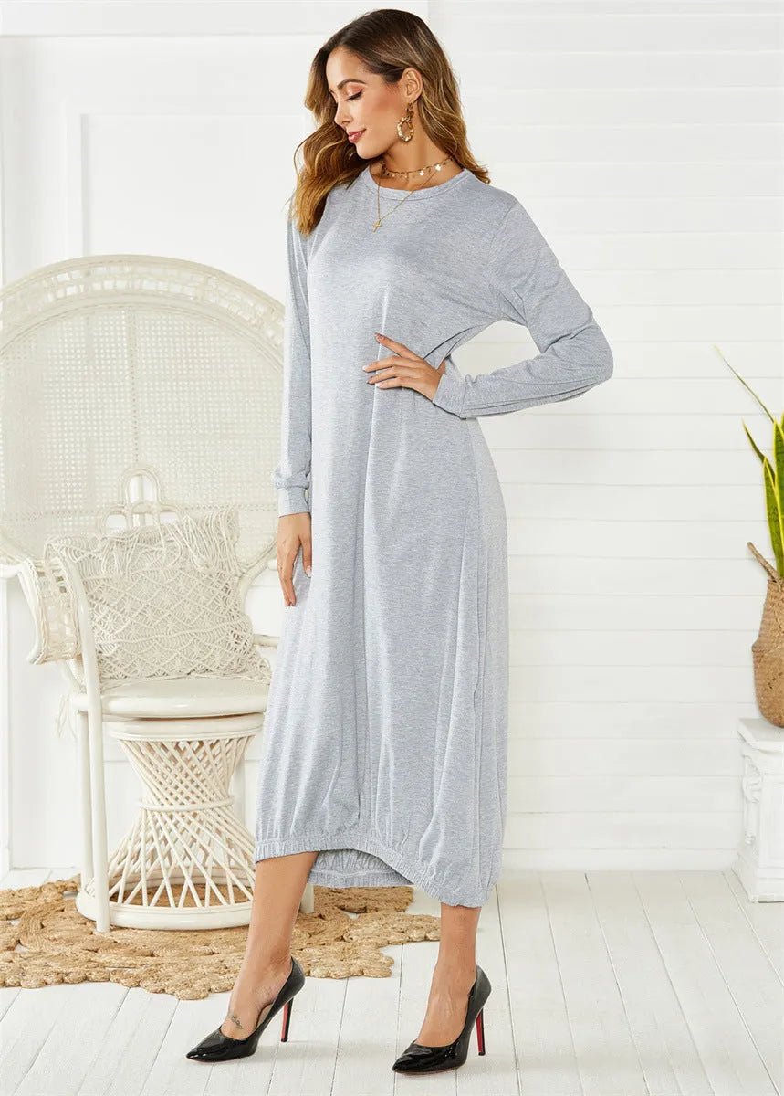 A loose-fitting, long black lantern dress with a lace-up detail at the crew neck, made from knitted polyester fabric.