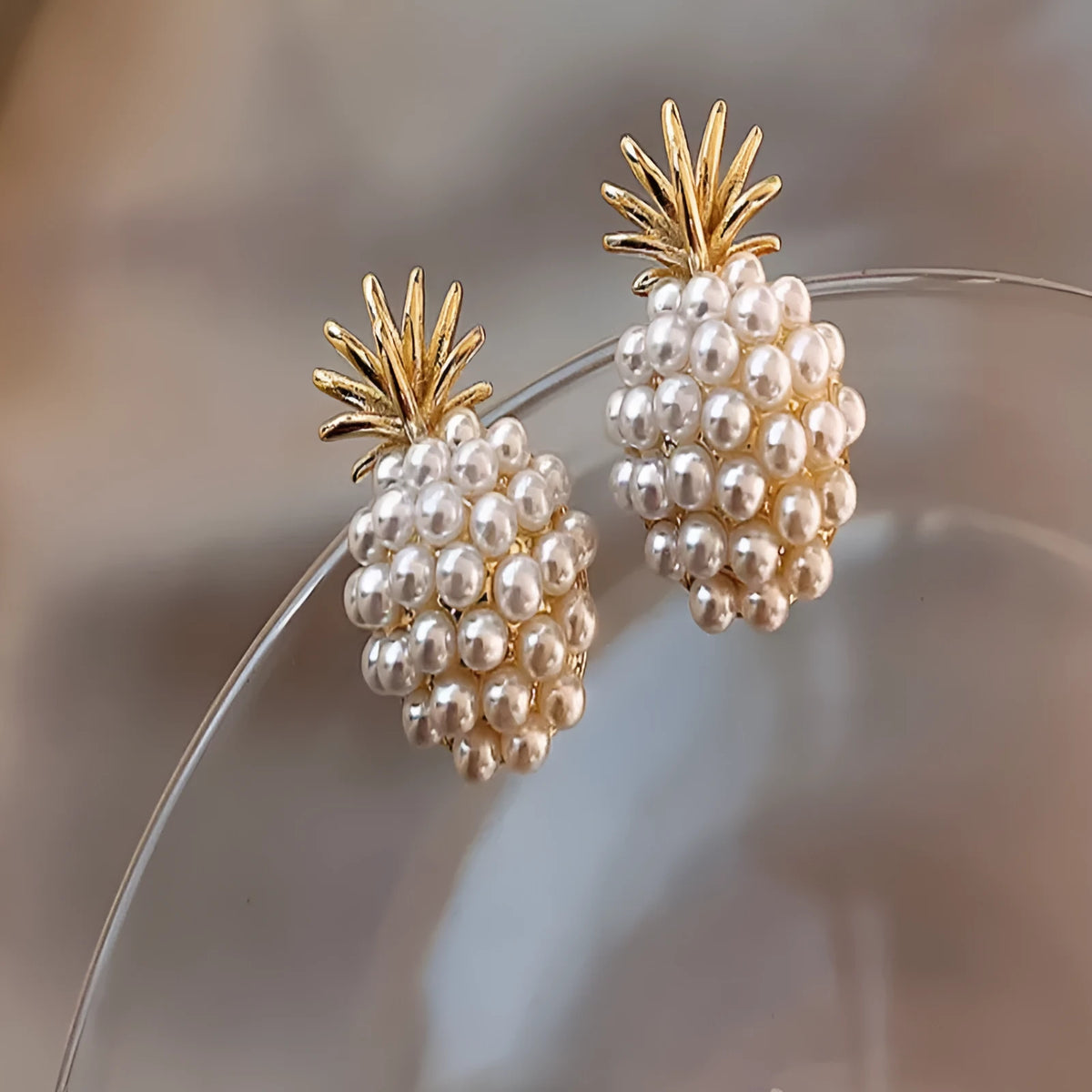 Korean style pineapple and starfish pearl design alloy earrings with electroplated gold, silver, pearl flower, and starfish pearl finishes.