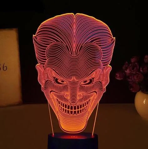 USB-powered 3D acrylic LED table lamp with remote control on a desk, displaying a gradient colour mode.
