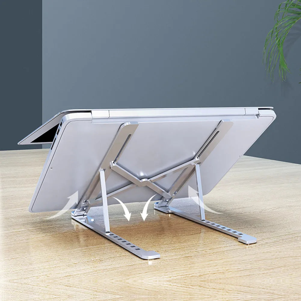 Silver aluminium laptop stand in folded and unfolded positions next to a 15-inch laptop.