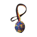 Yellow and camouflage coloured EVA floating dog chew balls in three different sizes on a blue background.