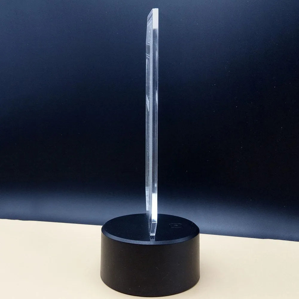 3D acrylic brain sculpture LED desk lamp with colourful illumination on a dark surface.