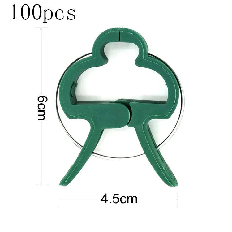 Green plastic plant fixing clips for supporting climbing vegetables and garden vines