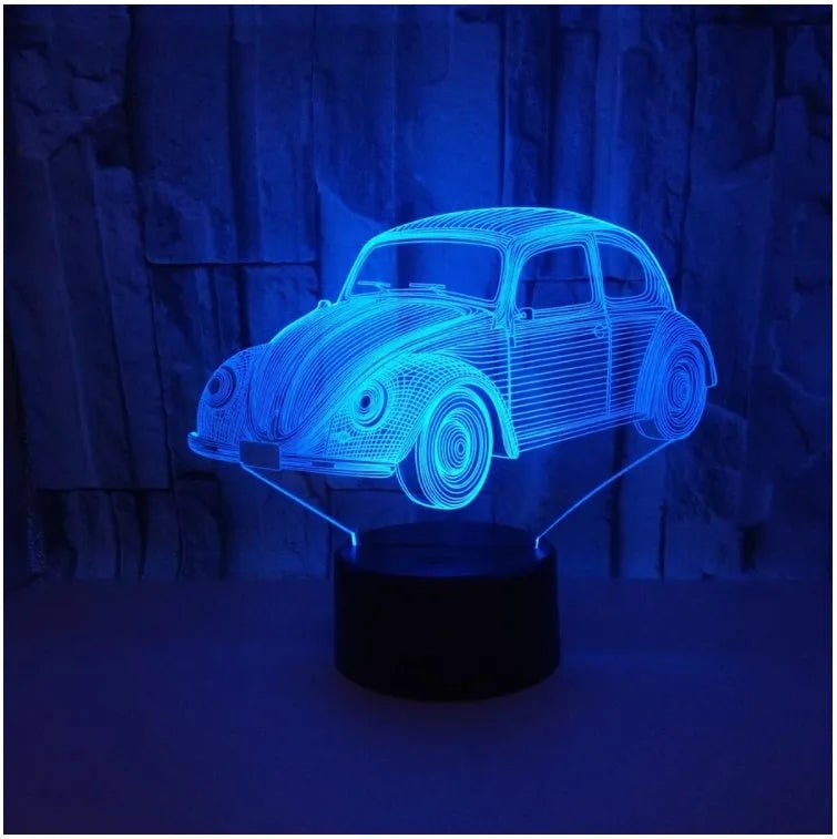 Modern black or crack finish 3D LED table lamp with touch controls and remote on a desk.