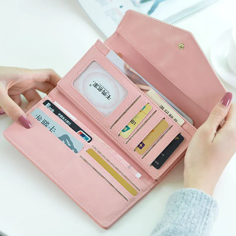 Open view of a large capacity three-fold women's wallet showing multiple card slots and a zipped coin purse.