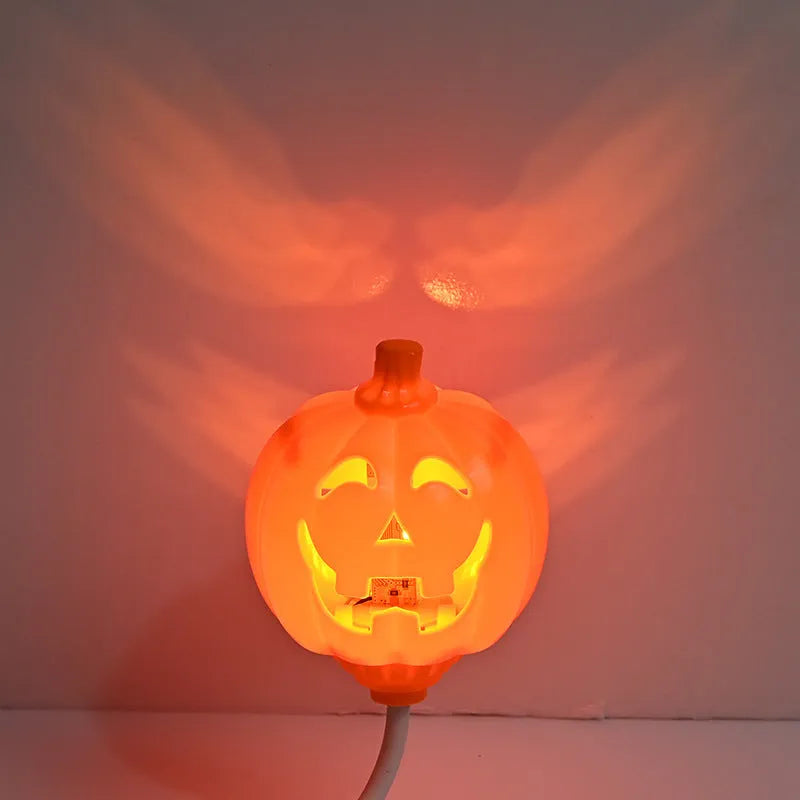 Plastic pumpkin-shaped USB rechargeable lamp glowing with either yellow or purple light, measuring 22cm tall.