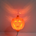 Plastic pumpkin-shaped USB rechargeable lamp glowing with either yellow or purple light, measuring 22cm tall.