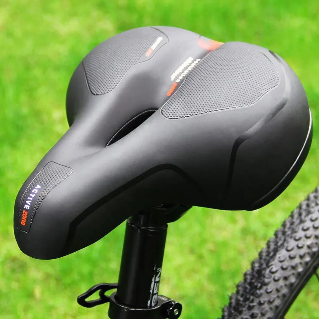 Hollow seat cushion bicycle saddle with PU leather cover, memory foam pad, and PP base, 26x21cm, in blue, red, or yellow.