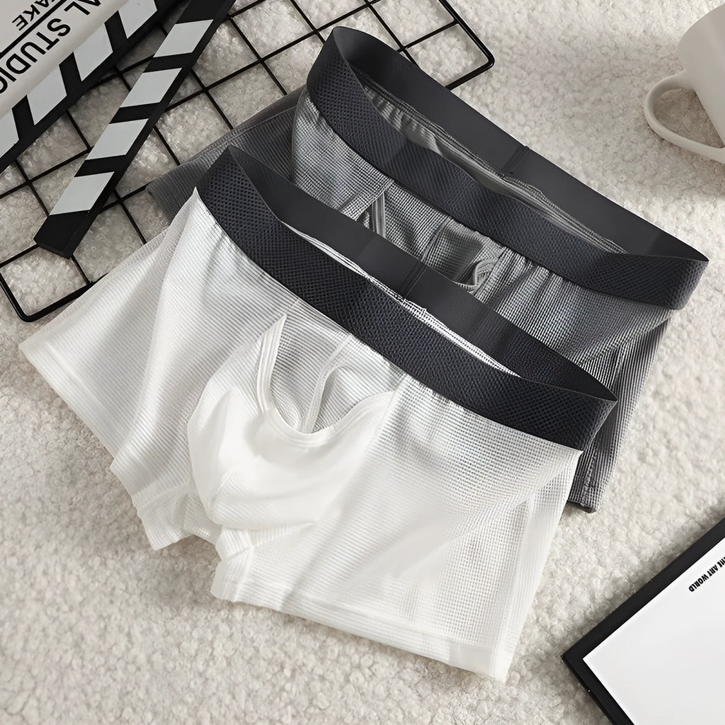 Men's ice silk boxer shorts in black colour showing low-waist design and mesh fabric texture