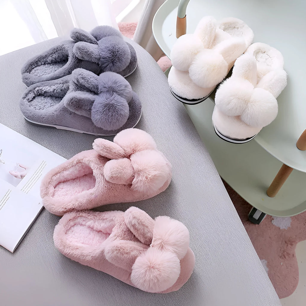 Women's high-top rabbit fur slippers in creamy white with floral detail and a sewn sole.
