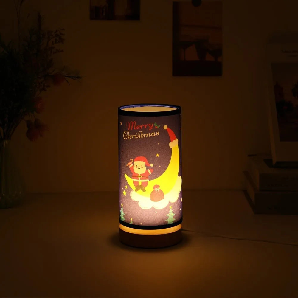 Moon-shaped Santa Claus LED night light with USB plug on bamboo base.