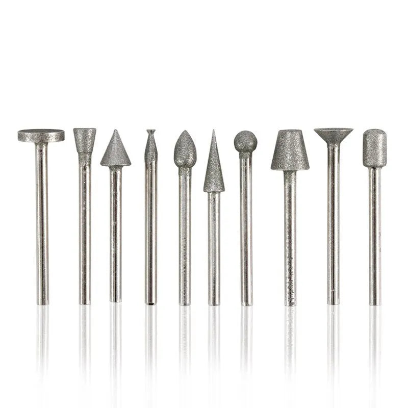 Close-up of an elliptical cone shaped alloy grinding head with a 3mm shank on a textured surface.