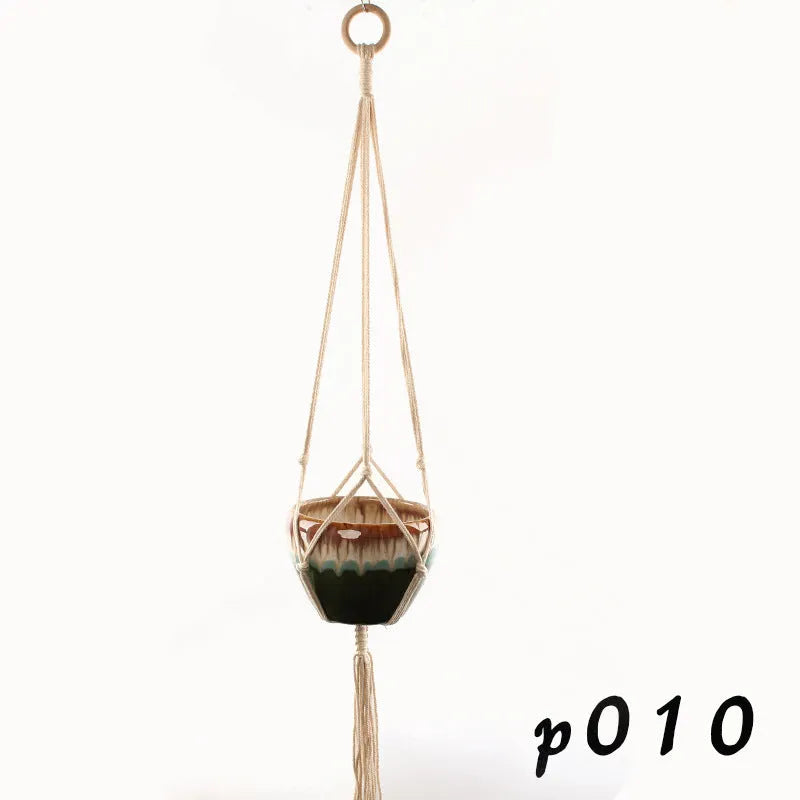 Woven cotton rope plant hanger in wall hanging configuration with green plants