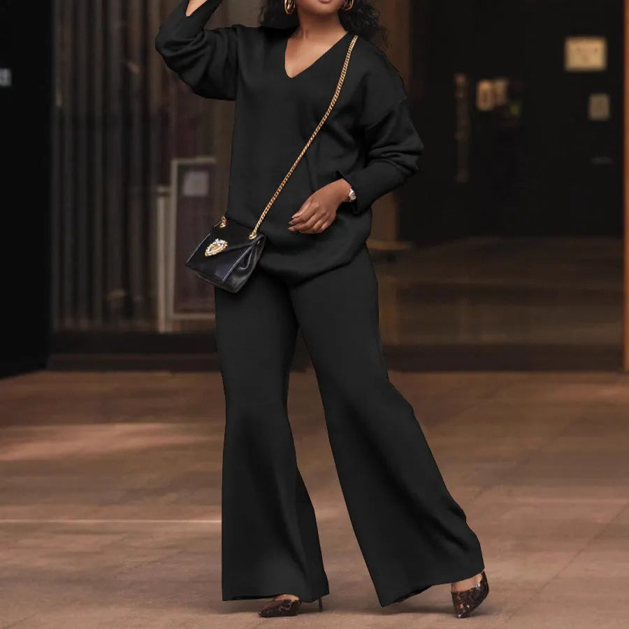 Brown women's casual two-piece suede suit with split sleeve top and trousers on a model.