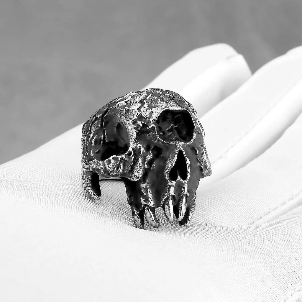 Alloy ring with a detailed one-eyed skull design on a finger, showing its metallic retro finish.