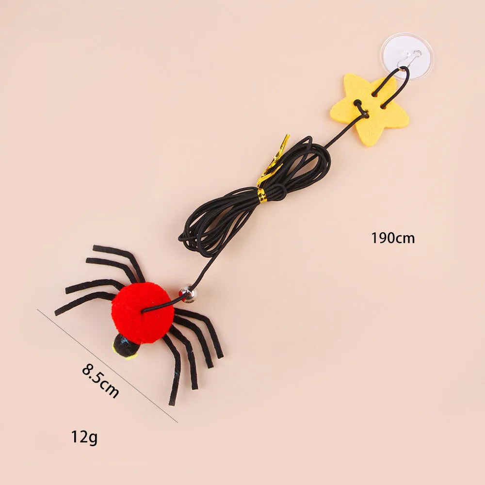 Red and yellow cat hanging door toy with elastic rope, feathers, a bell, and a spider attachment.