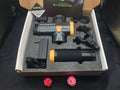 Black deep tissue fascia massage gun with four removable heads on a grey background