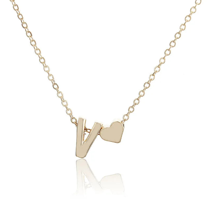 Peach heart shaped letter necklace pendant in gold alloy on display