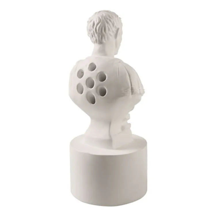 White synthetic resin pen holder with American creative character modelling design on a desk.