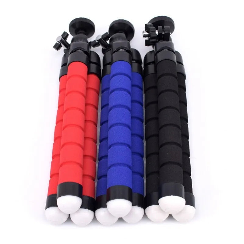 Black flexible octopus tripod with legs wrapped around a pole, holding a smartphone.