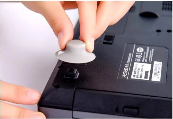 Two large and two small grey plastic laptop cooling pads on a flat surface.