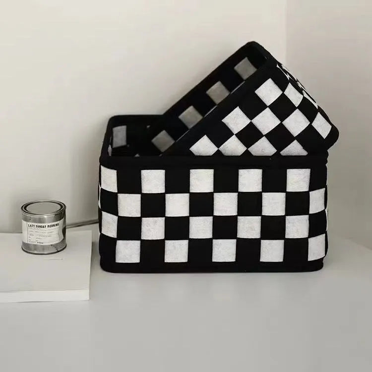 Checkerboard patterned woven felt storage basket folded flat next to it assembled