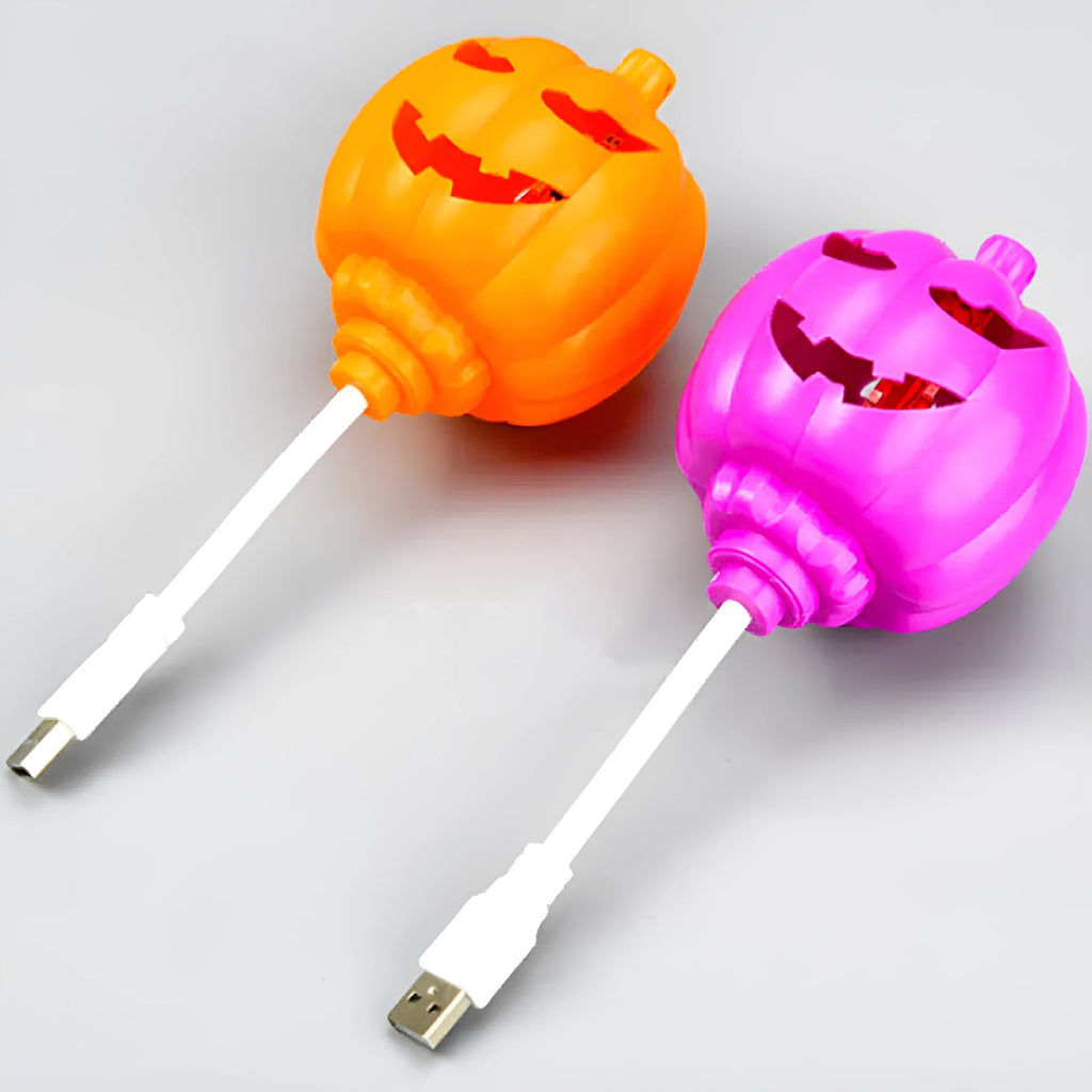 Plastic pumpkin-shaped USB rechargeable lamp glowing with either yellow or purple light, measuring 22cm tall.