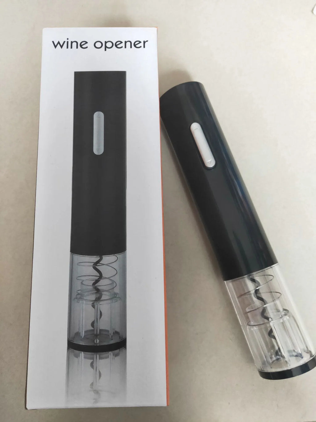 Black automatic electric wine bottle opener with foil cutter on silver wine bottle