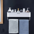 Adhesive plastic bathroom shelf mounted on wall holding shampoo and shower gel bottles