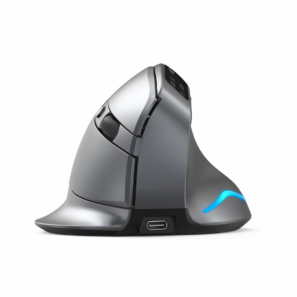 Grey handheld Bluetooth vertical mouse on a desk next to a laptop.