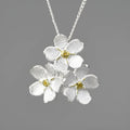 Sterling silver forget-me-not floral pendant in pastoral style, shown in gold and silver electroplated finishes.
